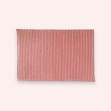 Red and cream narrow-stripe cotton linen placemat, 11.8 x 15.7 in (30 x 40 cm), on a soft blush backdrop