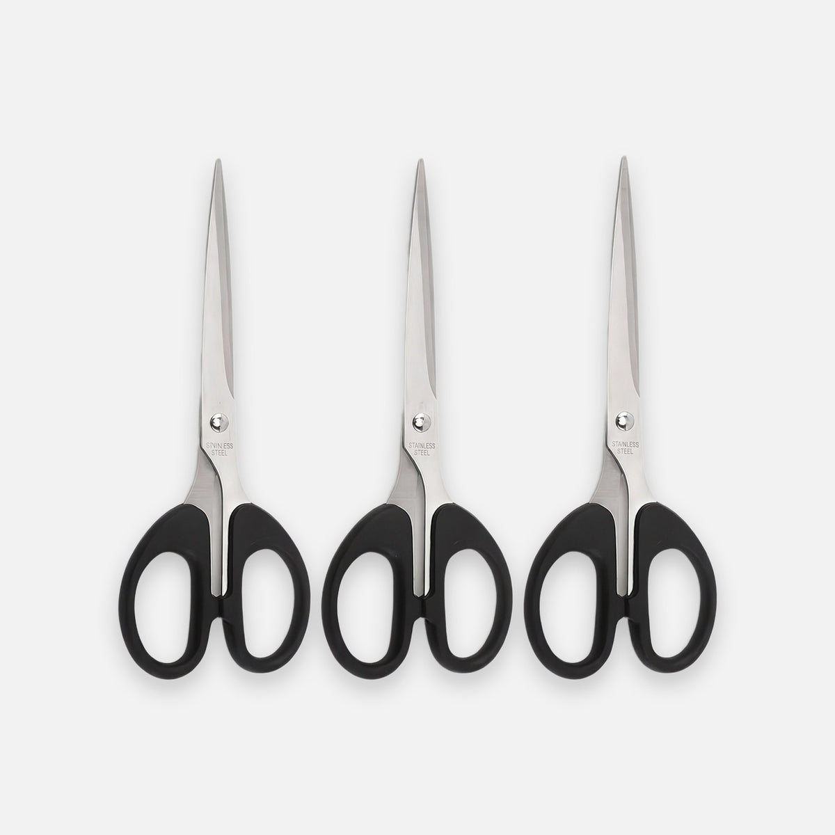 Three pairs of hair shears with black handles and silver stainless steel blades, arranged side-by-side on a light gray background.