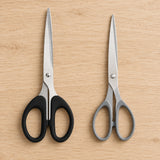 Comparison of the black soft-grip stainless steel scissors next to a basic pair with thin grey plastic loops