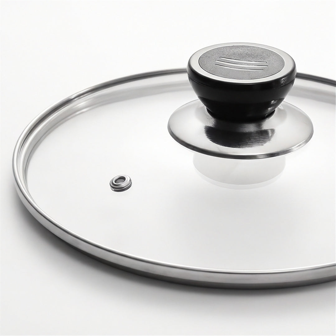 A clear glass lid with a polished silver metal rim and a black plastic handle, shown on a clean white background.