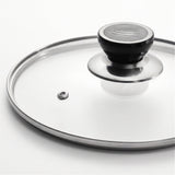 A clear glass lid with a polished silver metal rim and a black plastic handle, shown on a clean white background.