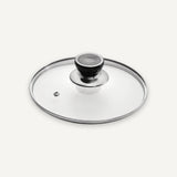 A clear glass lid with a polished silver metal rim and a black knob with a silver top, shown on a light gray background.