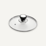 A clear glass lid with a polished silver metal rim and a black-and-white knob, shown on a light gray background.