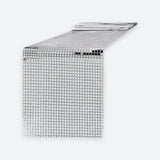 A silver disco ball mesh table runner with a reflective grid pattern, shown partially unrolled on a light gray background.