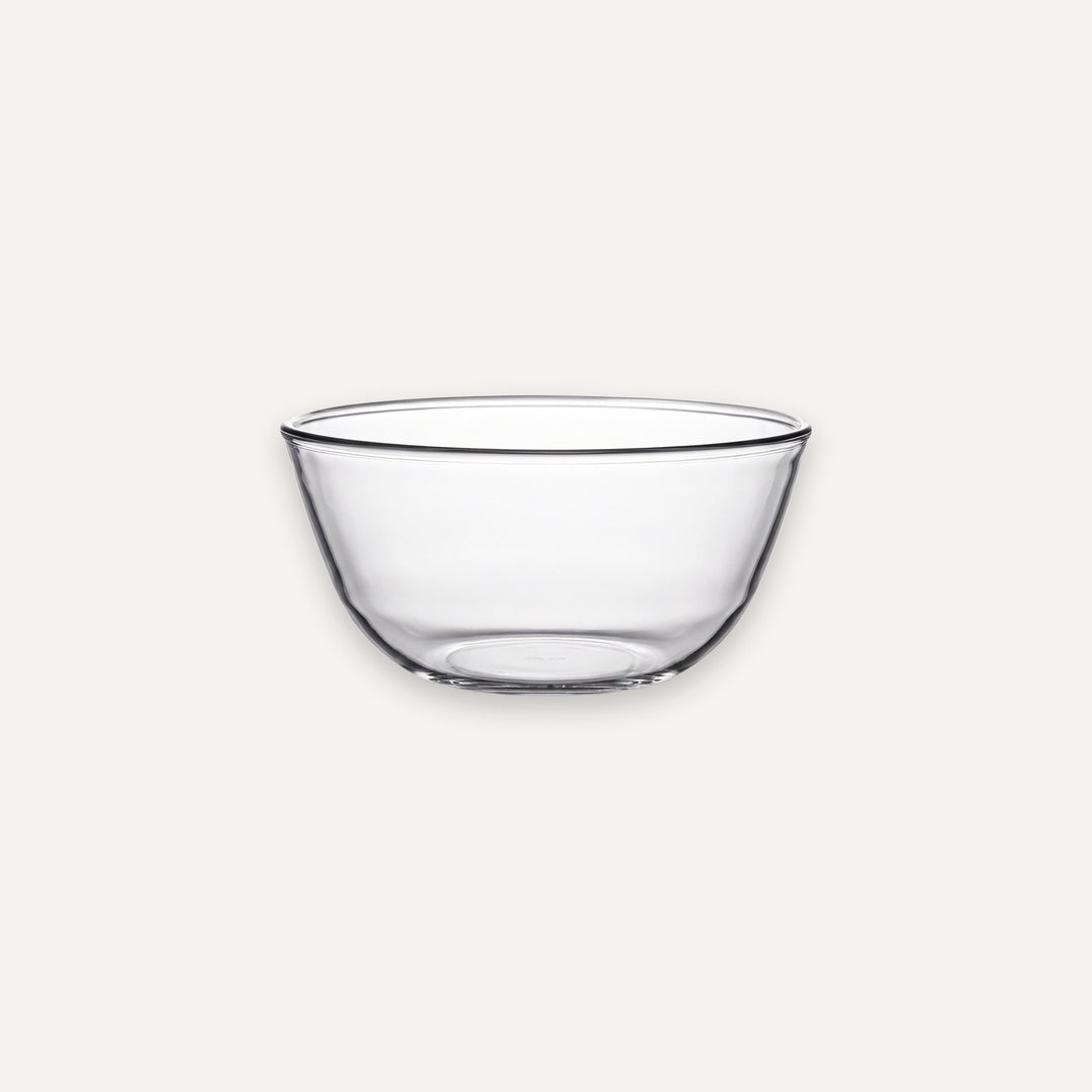 A clear glass bowl with a wide rim and slightly tapered base, shown against a plain light gray background.