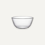 A clear glass bowl with a wide rim and slightly tapered base, shown against a plain light gray background.