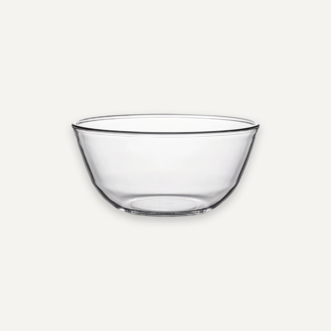 A clear glass bowl with a wide rim and gently curved sides, shown on a plain light gray background.