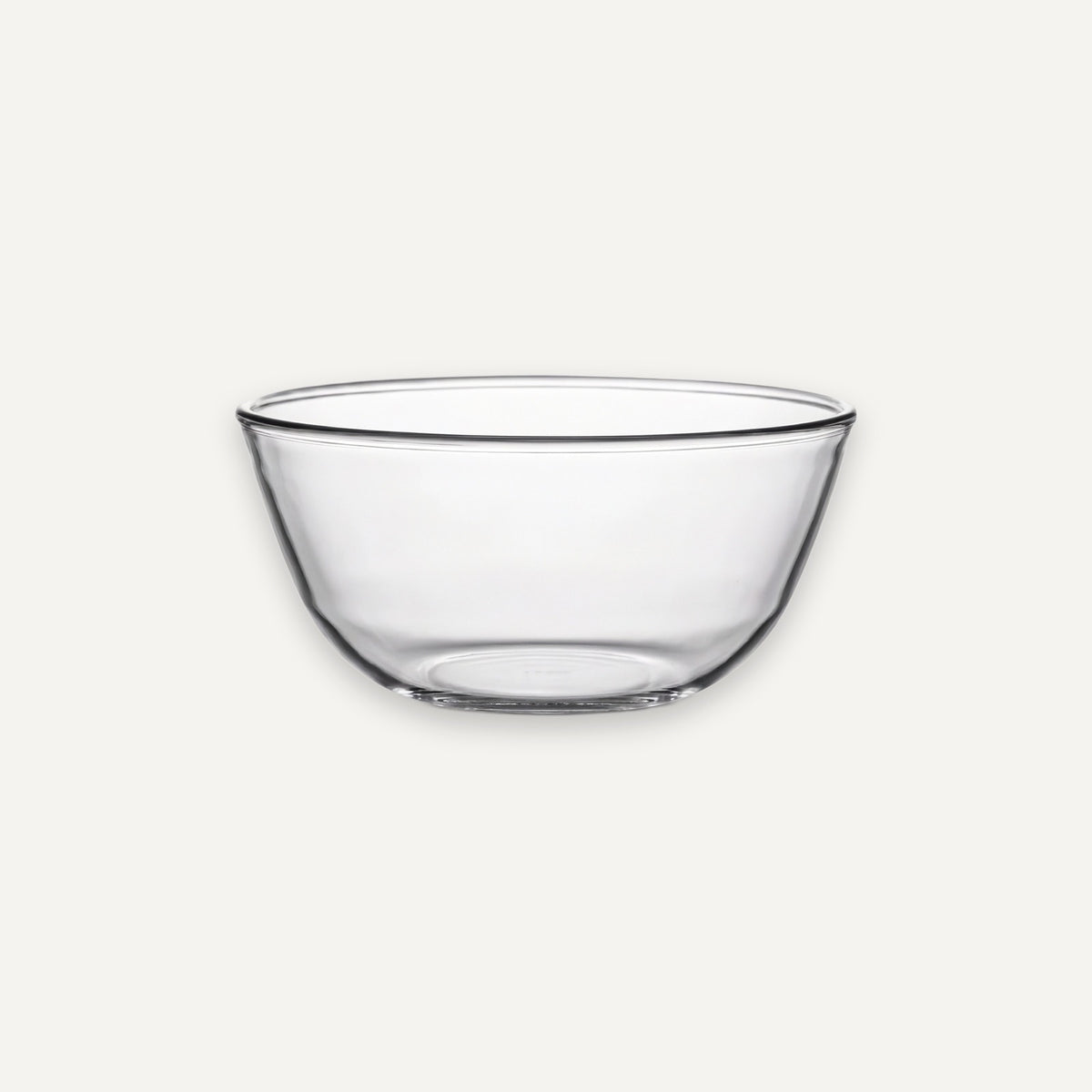 A clear glass bowl with a wide rim and gently curved sides, shown on a plain light gray background.