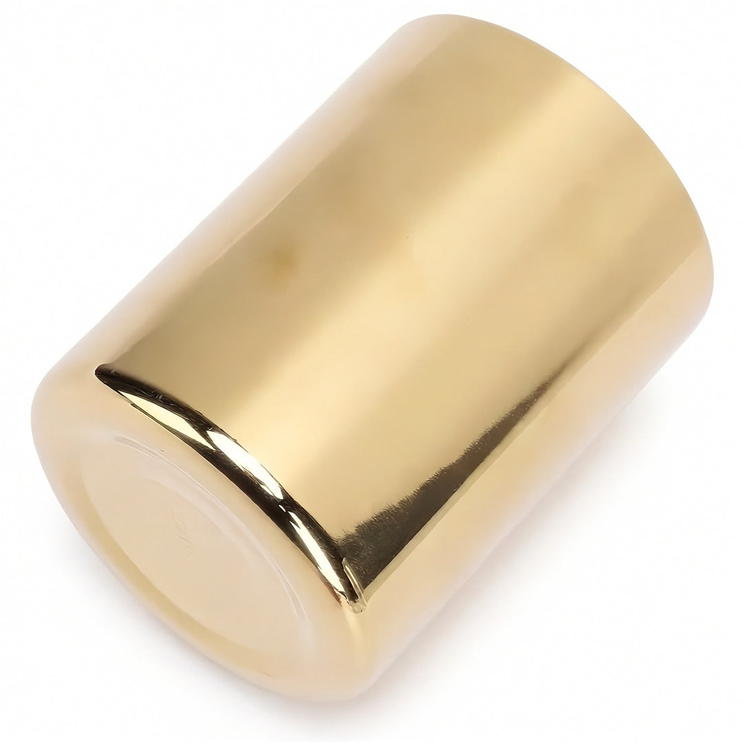A shiny gold metallic cylindrical cap or cover, shown at an angle on a clean white background.