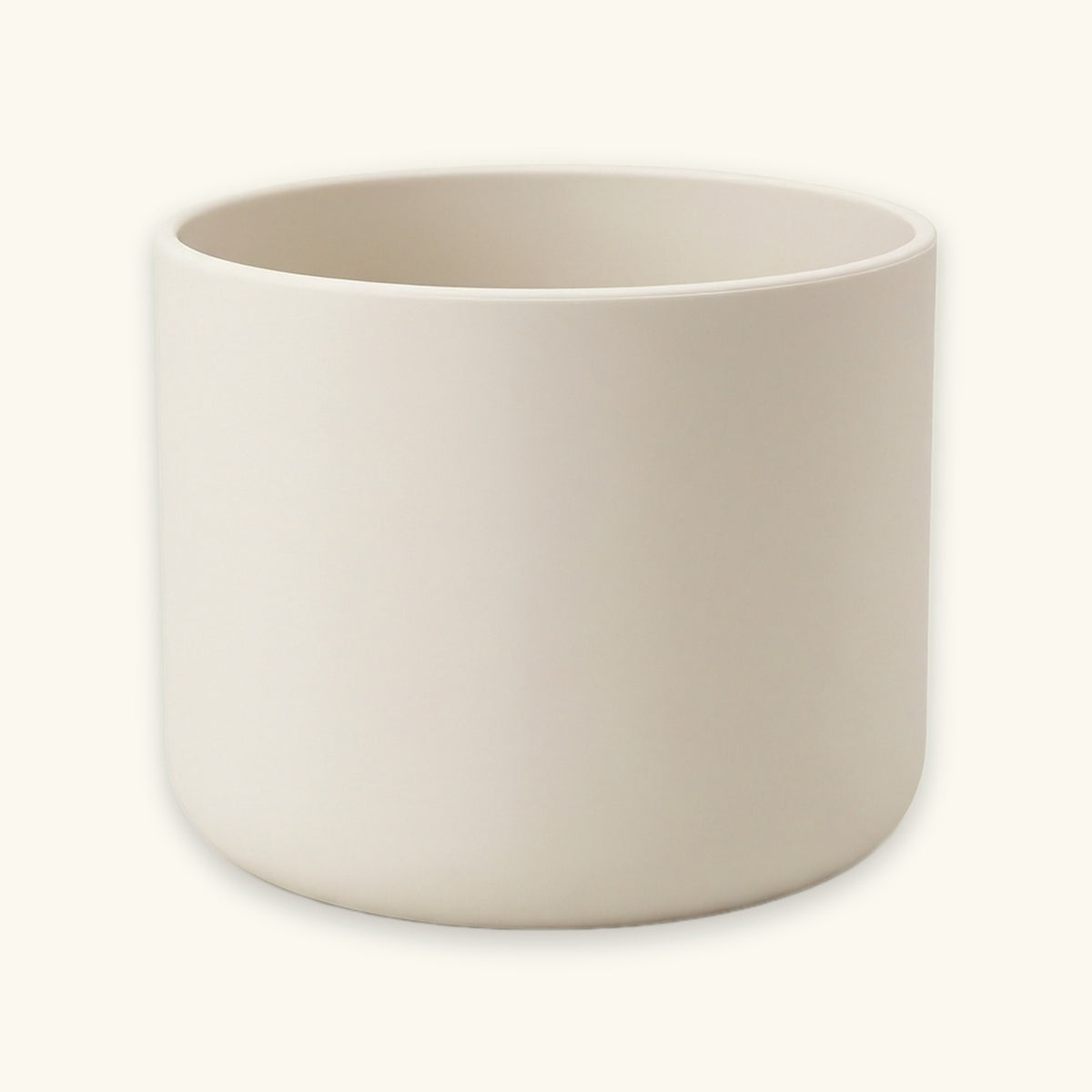 A minimalist, matte ceramic cylindrical planter in a warm off-white or cream color, shown against a matching light cream background.