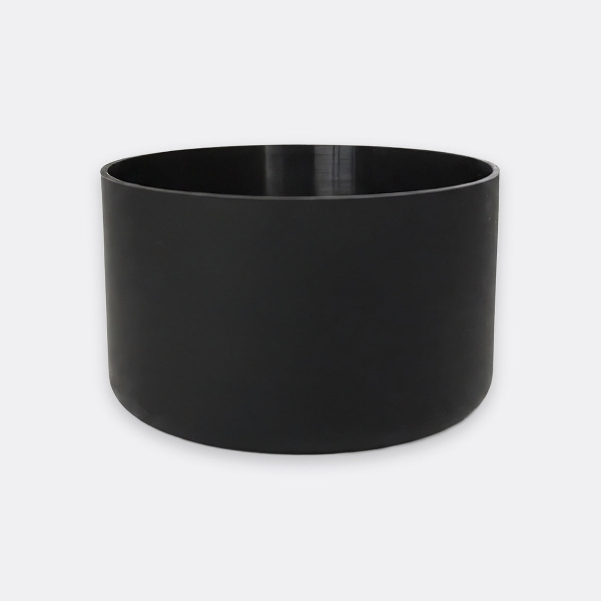 A matte black cylindrical planter pot with a wide rim, shown on a light gray background.