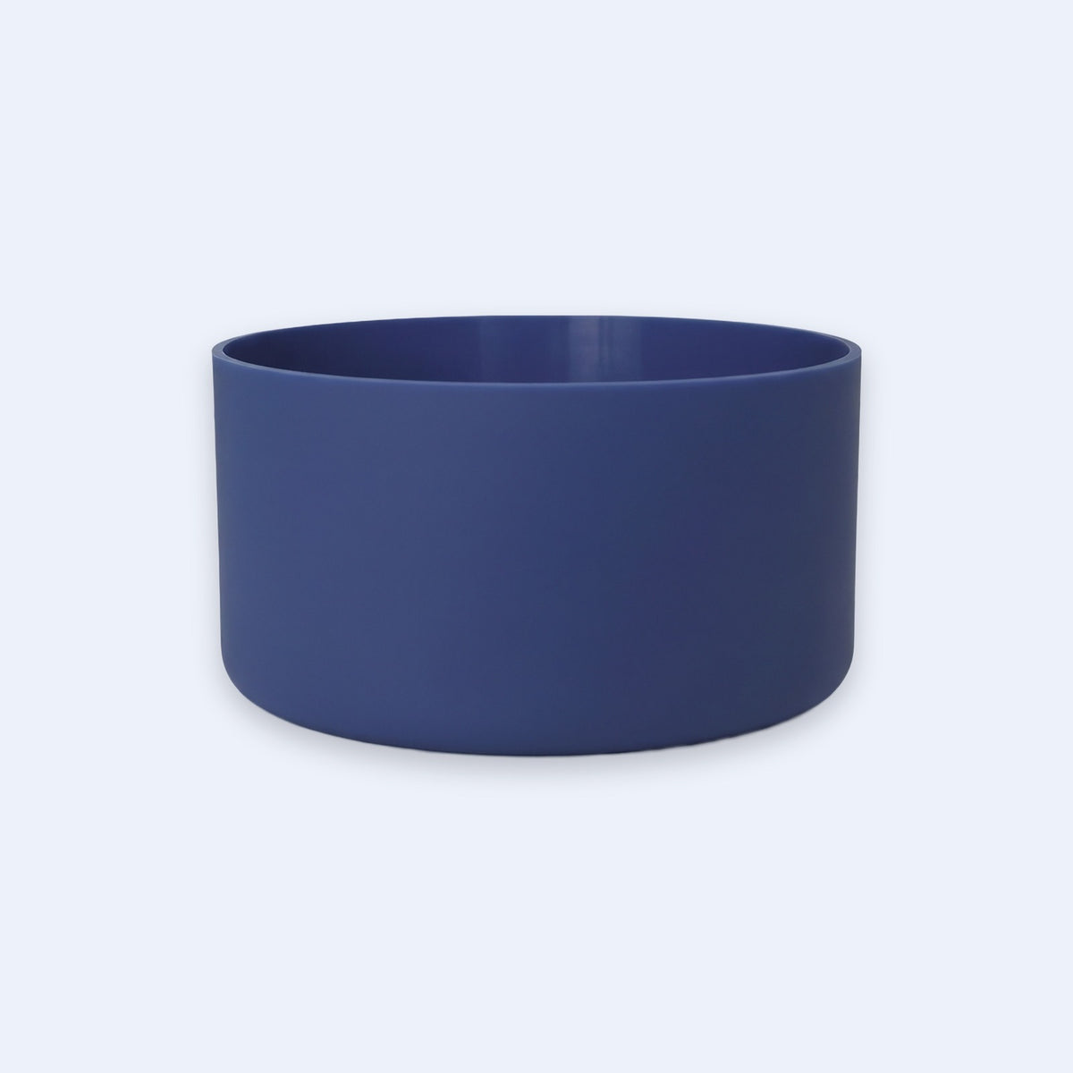 A matte navy blue cylindrical bowl or planter with a smooth finish, shown from a front three-quarter angle on a light gray background.