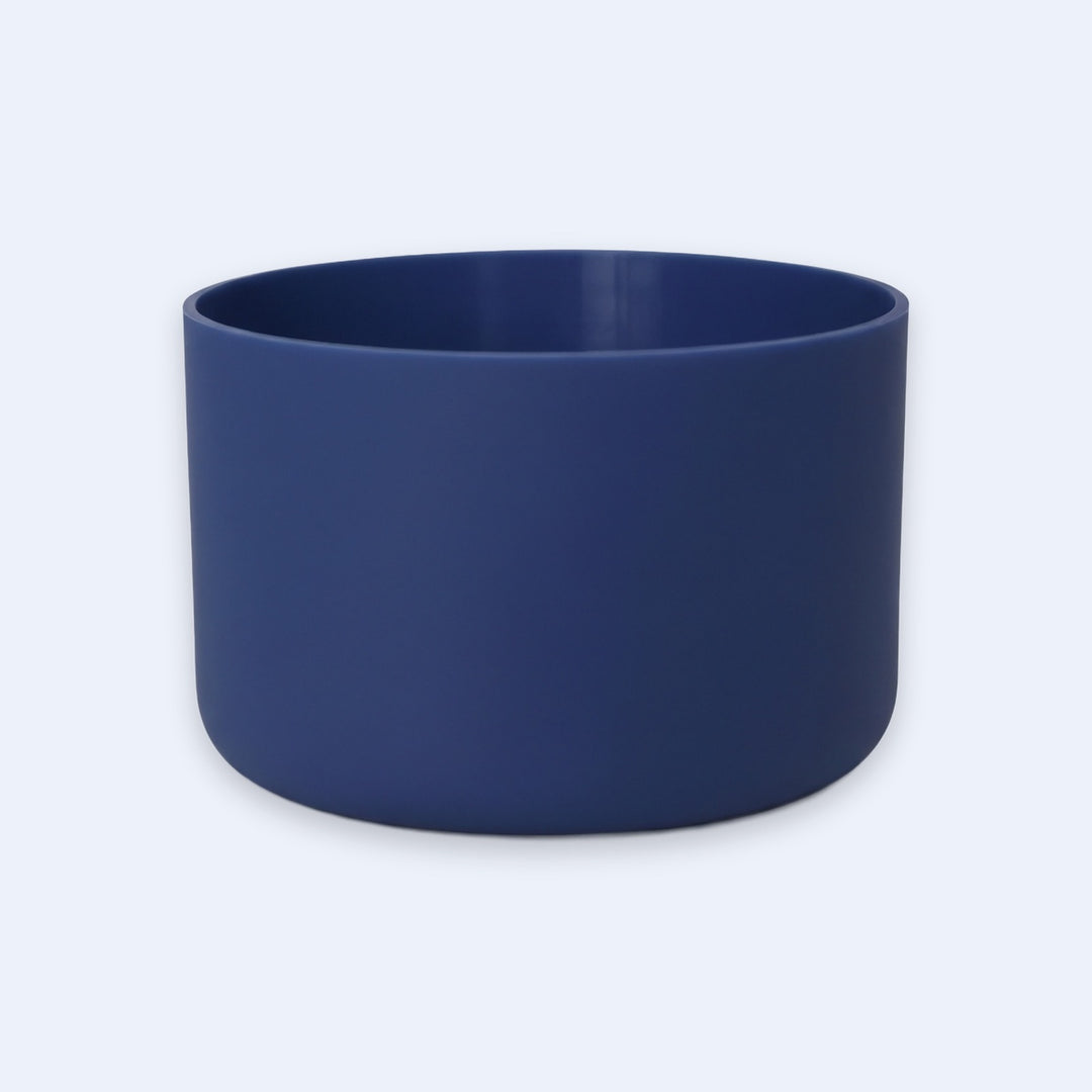 A matte navy blue cylindrical bowl or planter with a smooth finish, shown against a light gray background.