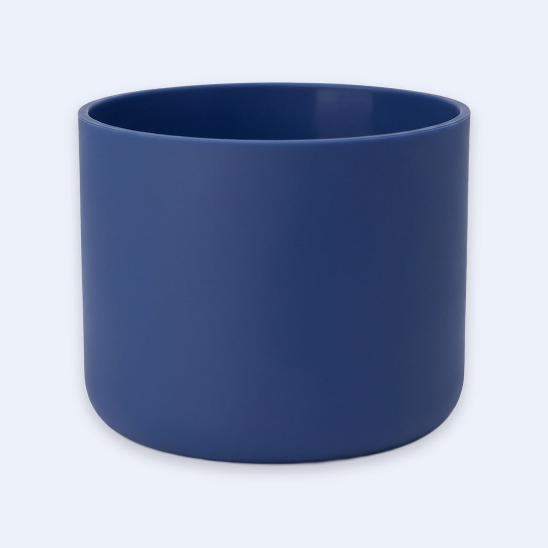 A matte navy blue cylindrical planter pot on a light gray background.