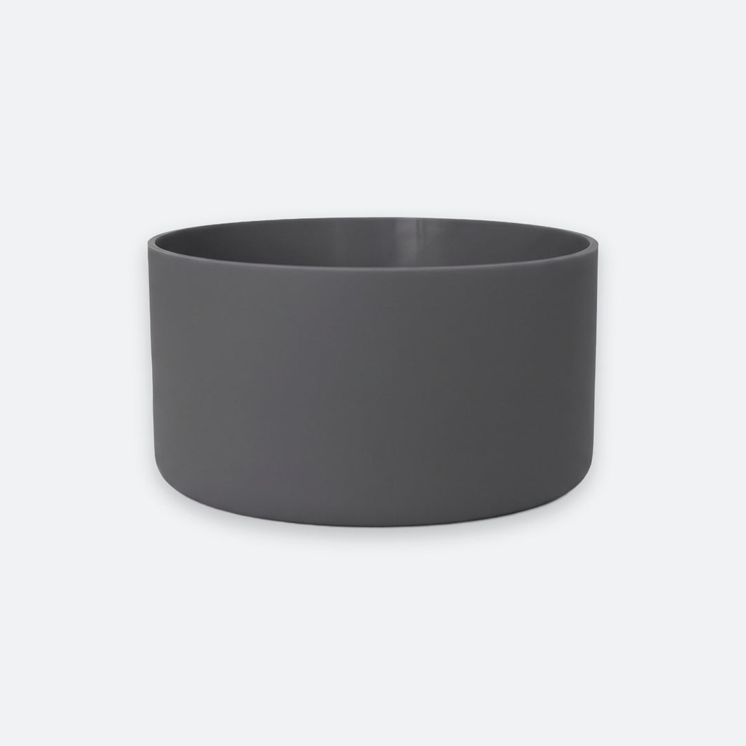 A dark gray cylindrical planter or bowl with a matte finish, shown against a light gray background.