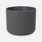 A matte dark gray cylindrical planter pot with a smooth, matte finish, shown against a light gray background.