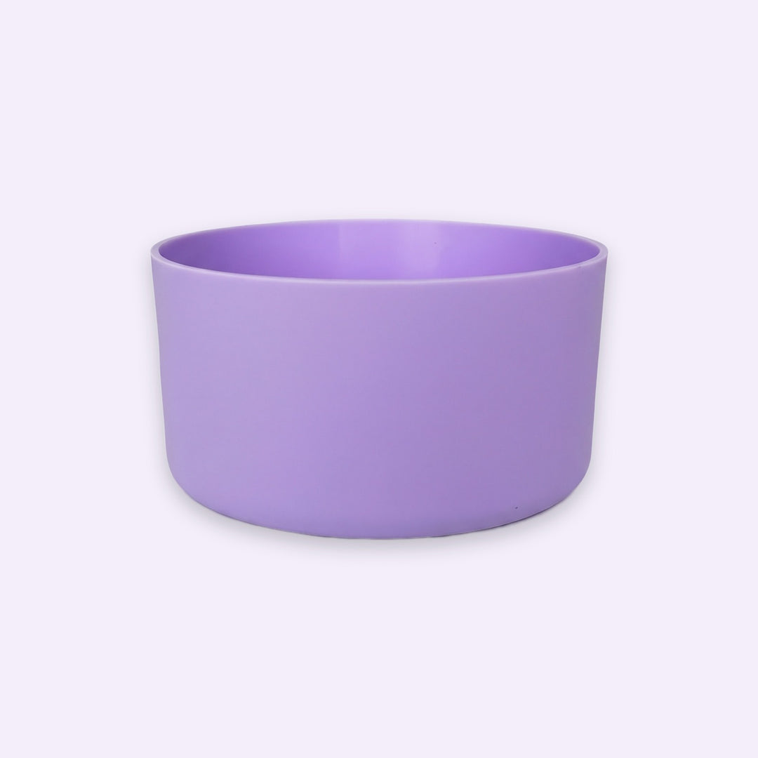 A lavender purple ceramic bowl with a matte finish, photographed from a direct side angle against a very light, almost white background.