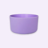 A lavender purple ceramic bowl with a matte finish, photographed from a direct side angle against a very light, almost white background.