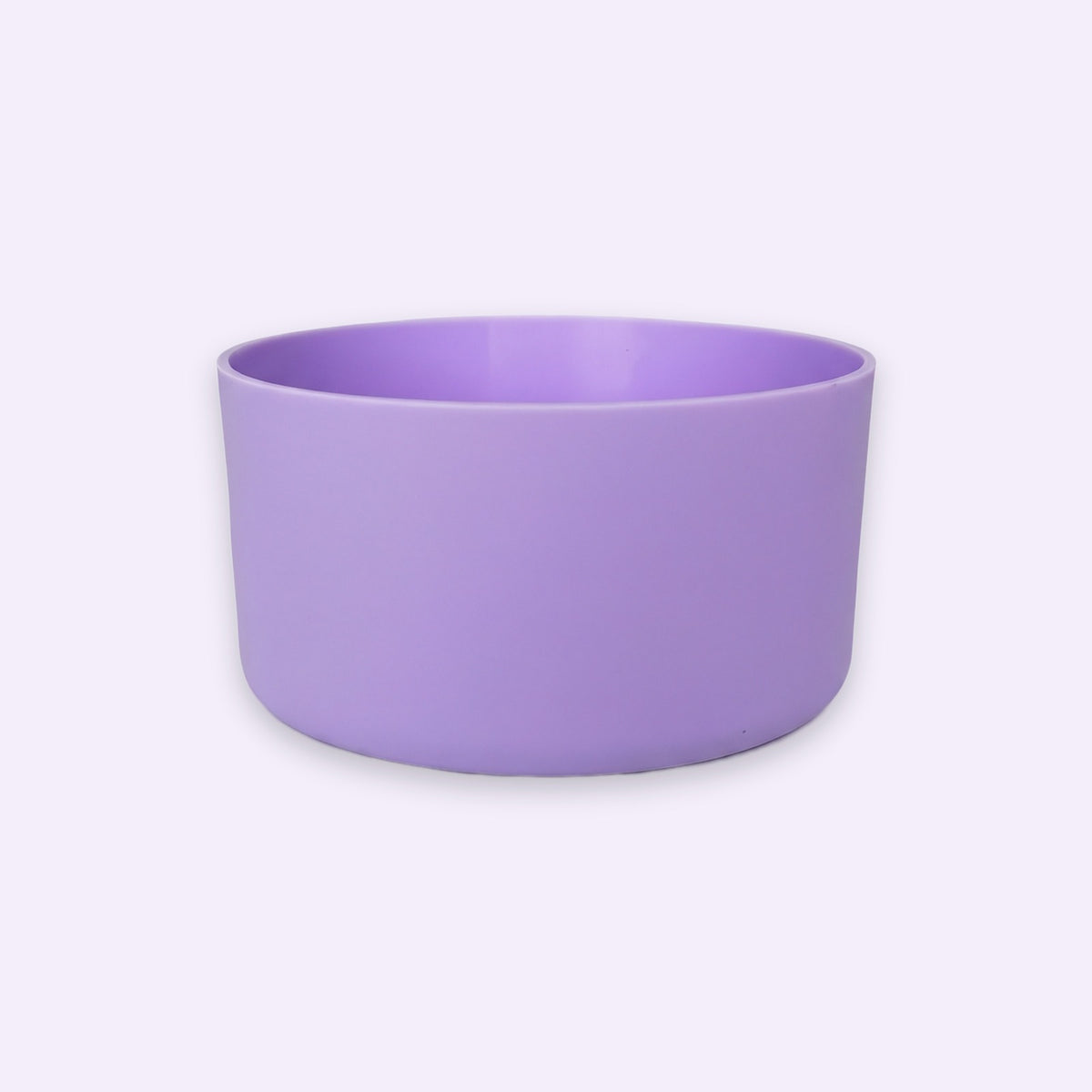 A lavender purple ceramic bowl with a matte finish, photographed from a direct side angle against a very light, almost white background.