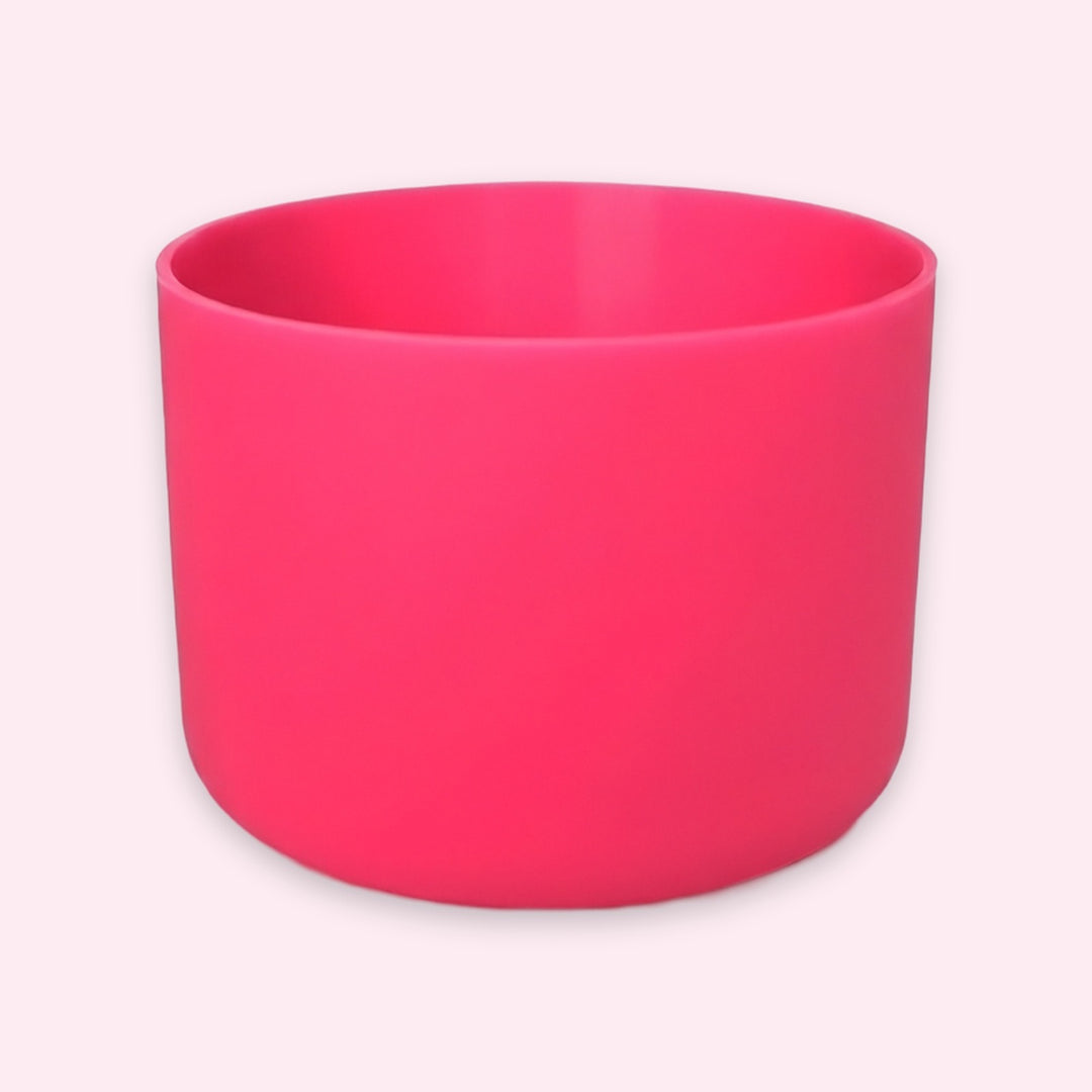 A bright pink cylindrical cup or planter with a matte finish, shown on a light pink background.
