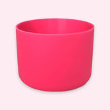 A bright pink cylindrical cup or planter with a matte finish, shown on a light pink background.