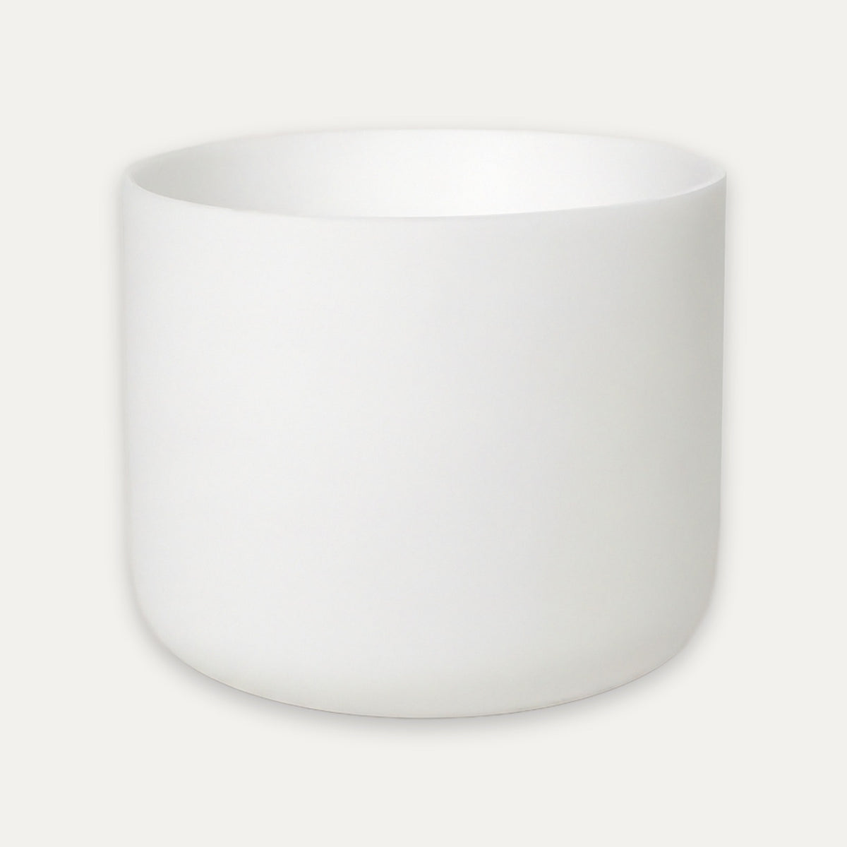 A minimalist white ceramic cup or small planter with a smooth matte finish, shown against a light off-white background.