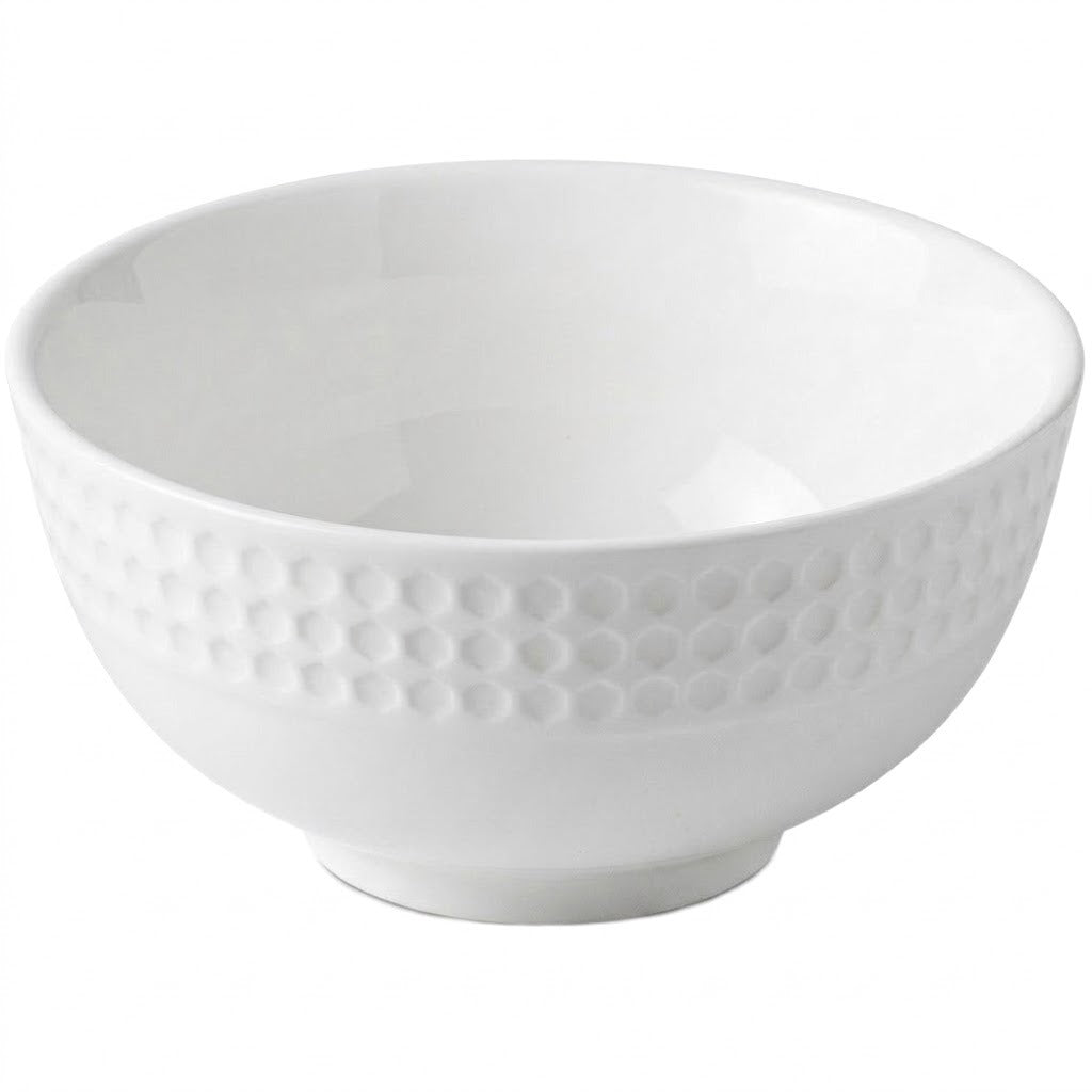 A white ceramic bowl with a textured, dimpled pattern around the outer side, shown on a plain white background.