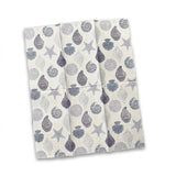 A folded white kitchen towel or napkin featuring a gray and blue-gray seashell and starfish pattern, shown against a plain white background.