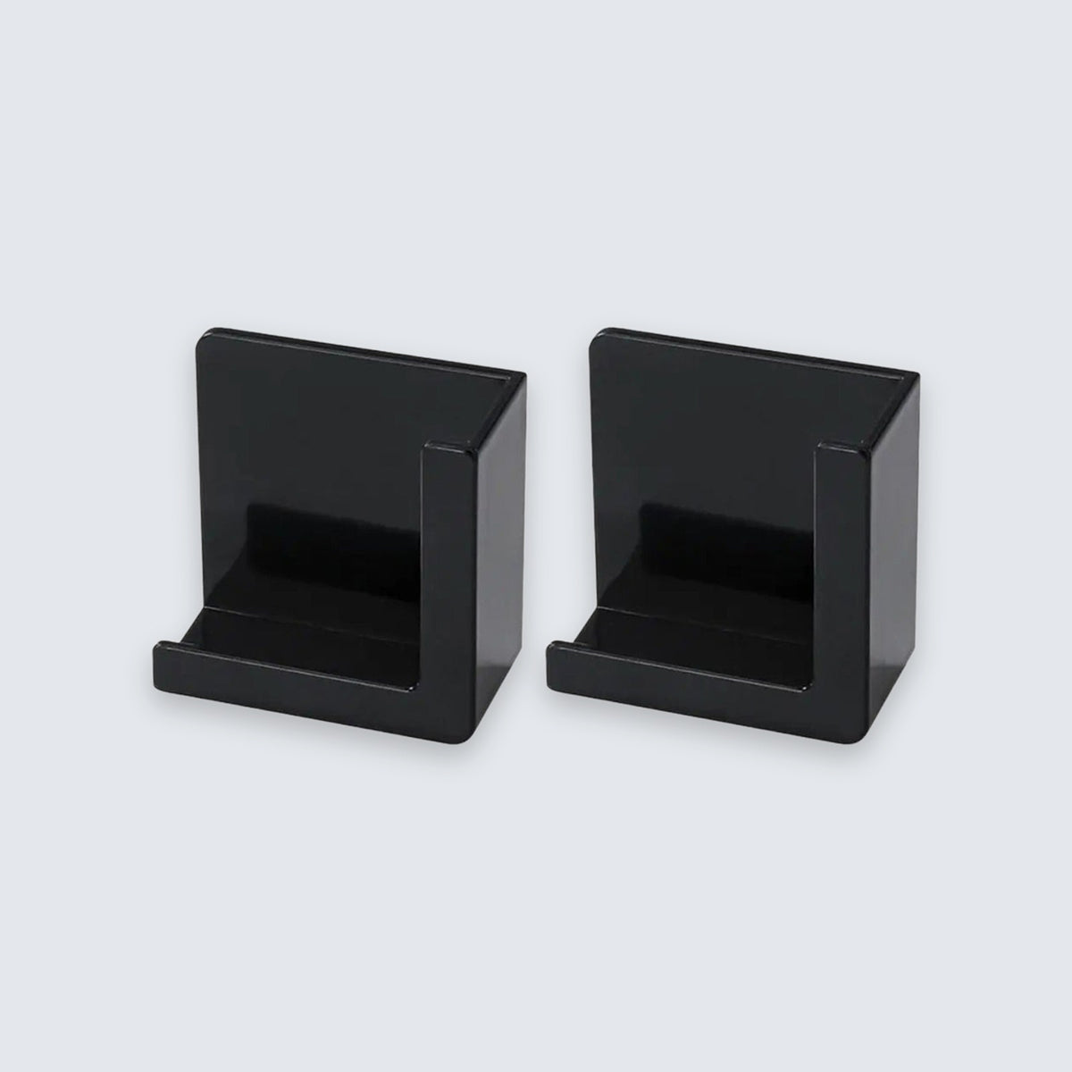 Two black plastic card holders or display stands shown side by side on a light gray background.