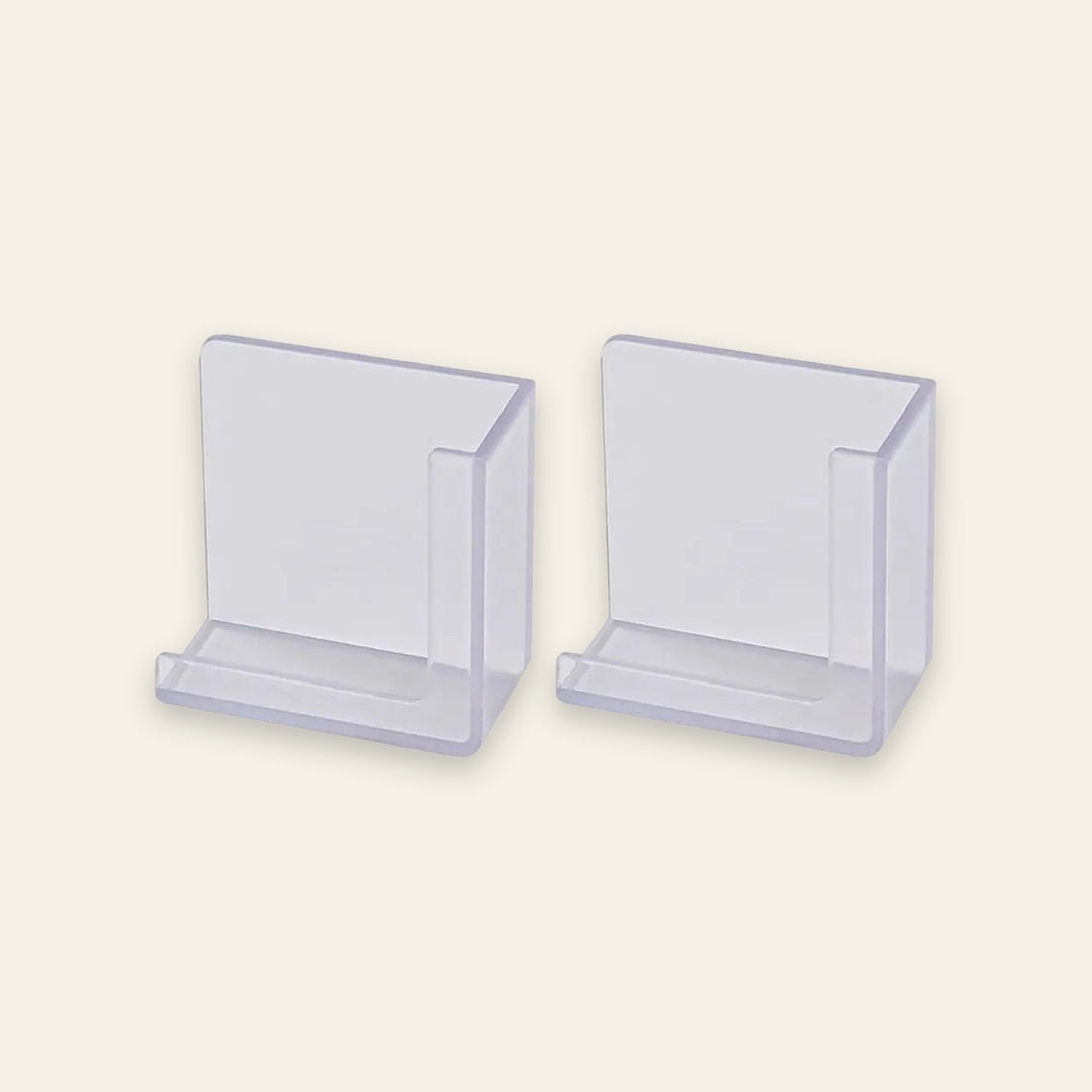 Two clear plastic card holders or display stands shown on a plain light beige background.