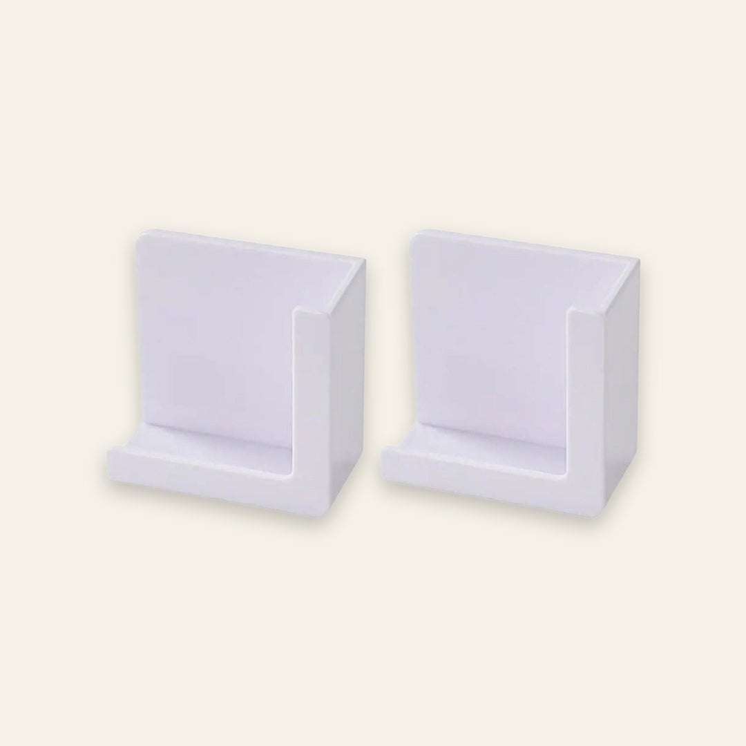 Two white plastic wall-mounted display holders shown side by side on a plain off-white background.