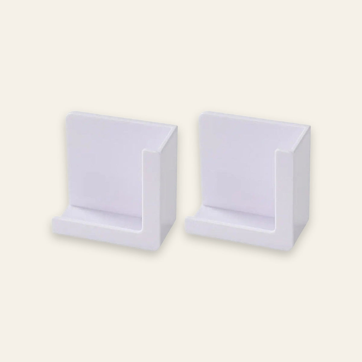 Two white plastic wall-mounted display holders shown side by side on a plain off-white background.