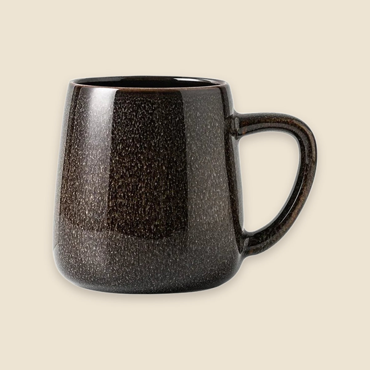 A dark brown ceramic mug with a speckled, textured glaze and a C-shaped handle, shown against a solid light beige background.