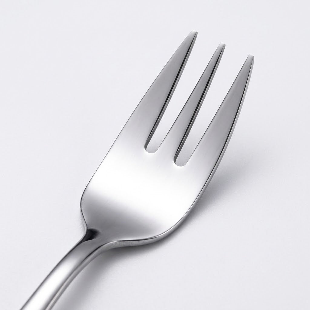 A close-up studio shot of a polished stainless steel dinner fork on a clean, light gray background.