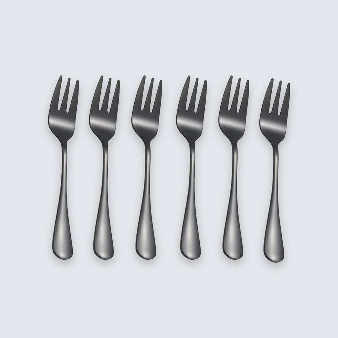 Six dark gray metal forks arranged in a row on a light gray background.