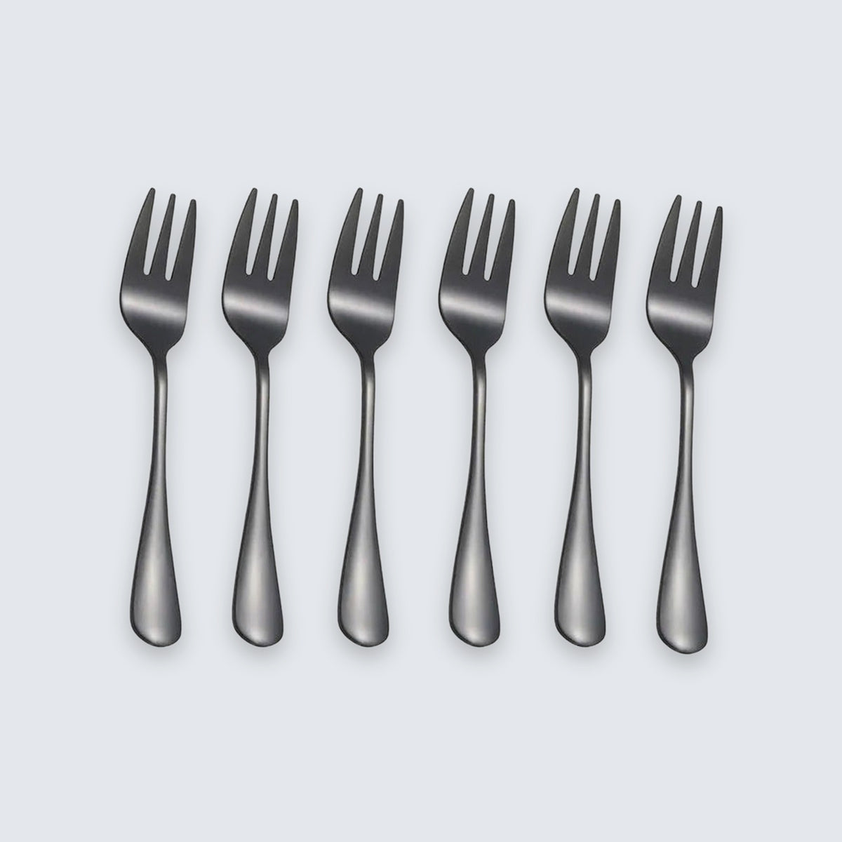 Six dark gray metal forks arranged in a row on a light gray background.