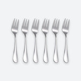 Six stainless steel dinner forks arranged in a row on a light gray background.