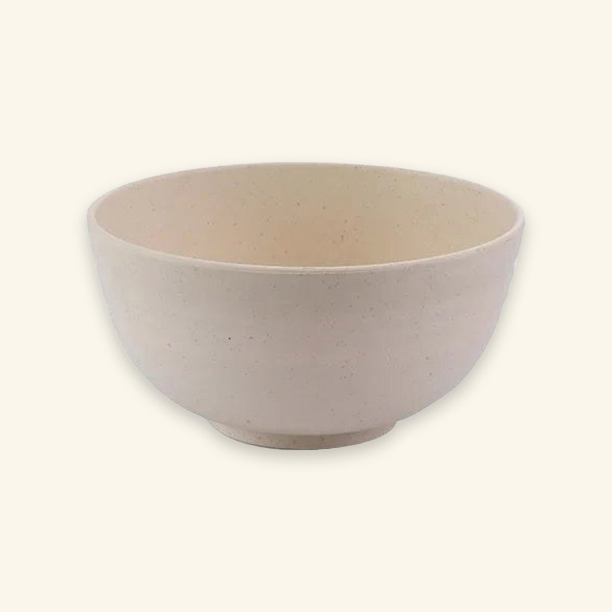 An empty beige speckled bowl with rounded sides and a small circular base sits against a cream background.
