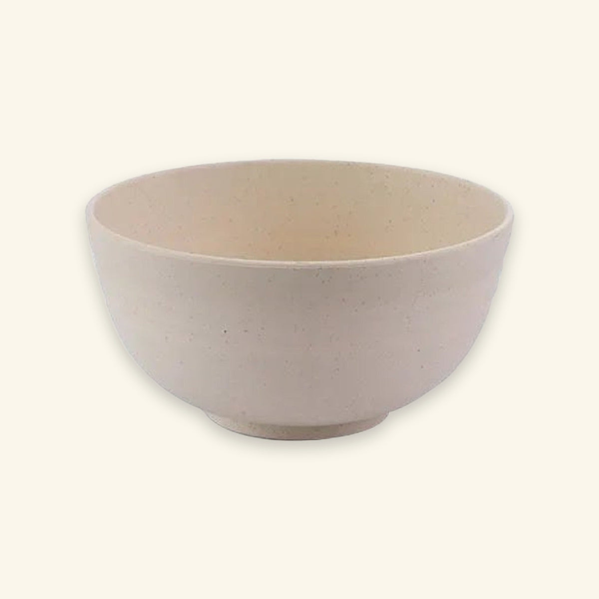 A lightly speckled beige bowl with rounded sides and a raised circular base sits against a cream background.