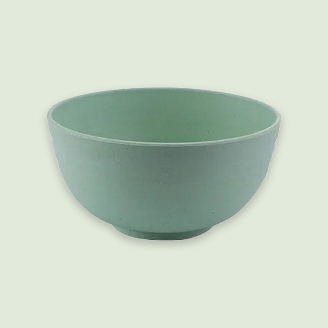 A green bowl with an open top and rounded sides sits on a circular base against a pale green background.