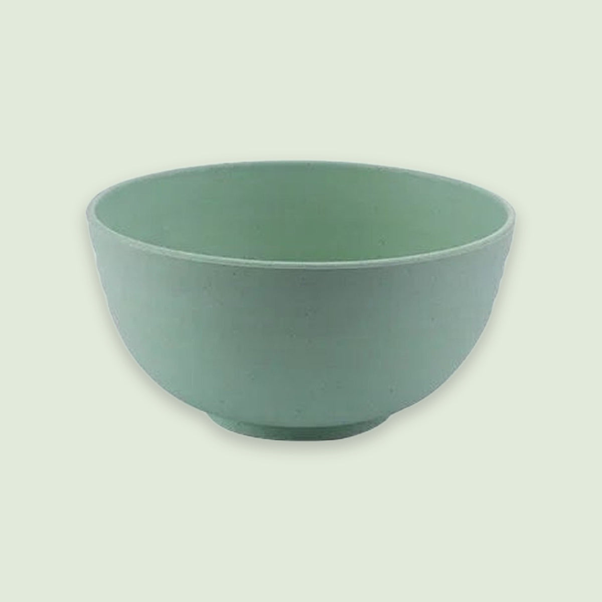 A green bowl with an open top and rounded sides sits on a circular base against a pale green background.