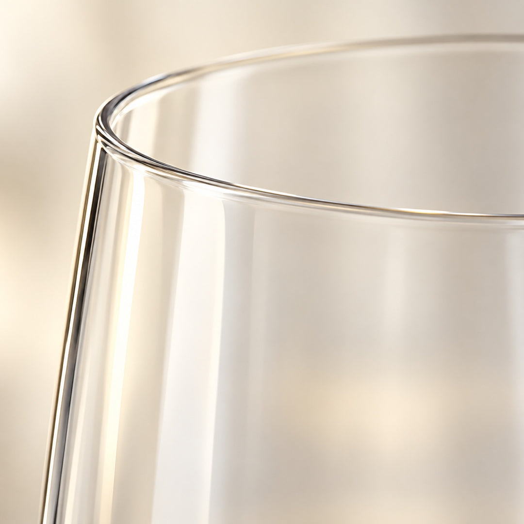Close-up of the thin, smooth rim of a clear Tritan plastic champagne flute