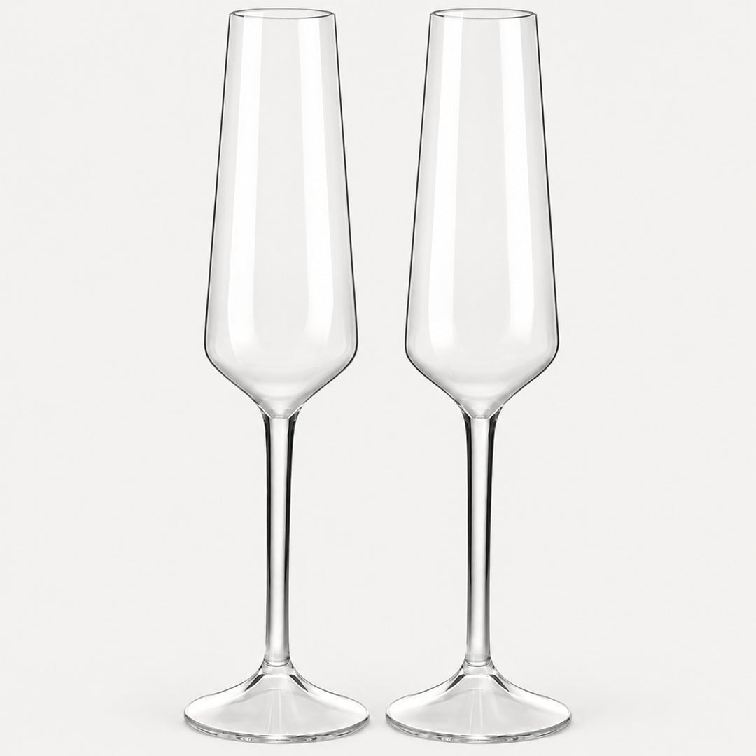 Set of 2 angular clear Tritan plastic champagne flutes on a light warm grey backdrop