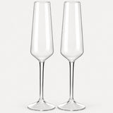Set of 2 angular clear Tritan plastic champagne flutes on a light warm grey backdrop