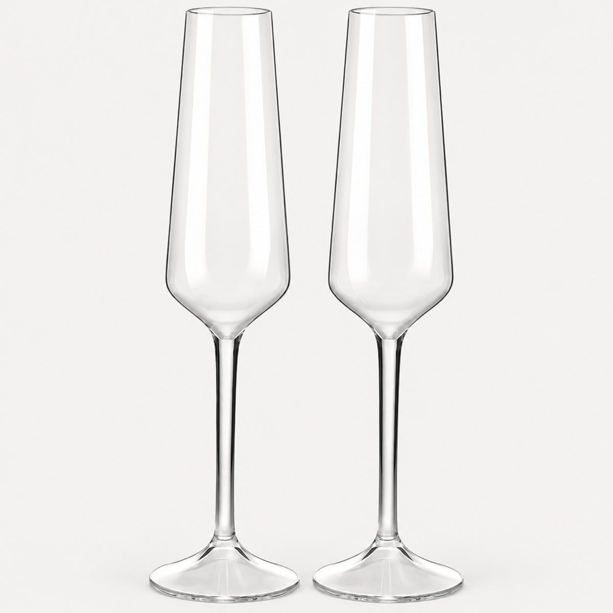 Set of 2 angular clear Tritan plastic champagne flutes on a light warm grey backdrop