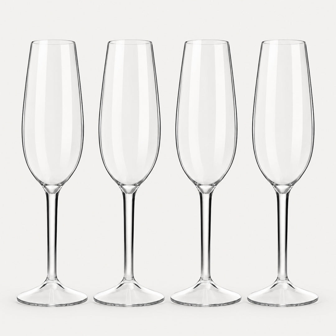 Set of 4 rounded clear Tritan plastic champagne flutes on a light warm grey backdrop