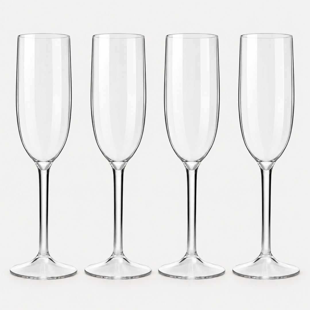 Set of 4 straight-sided clear Tritan plastic champagne flutes on a light warm grey backdrop