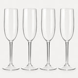 Set of 4 straight-sided clear Tritan plastic champagne flutes on a light warm grey backdrop