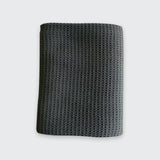 A dark gray waffle-knit fabric sleeve or pouch, shown flat against a light gray background.