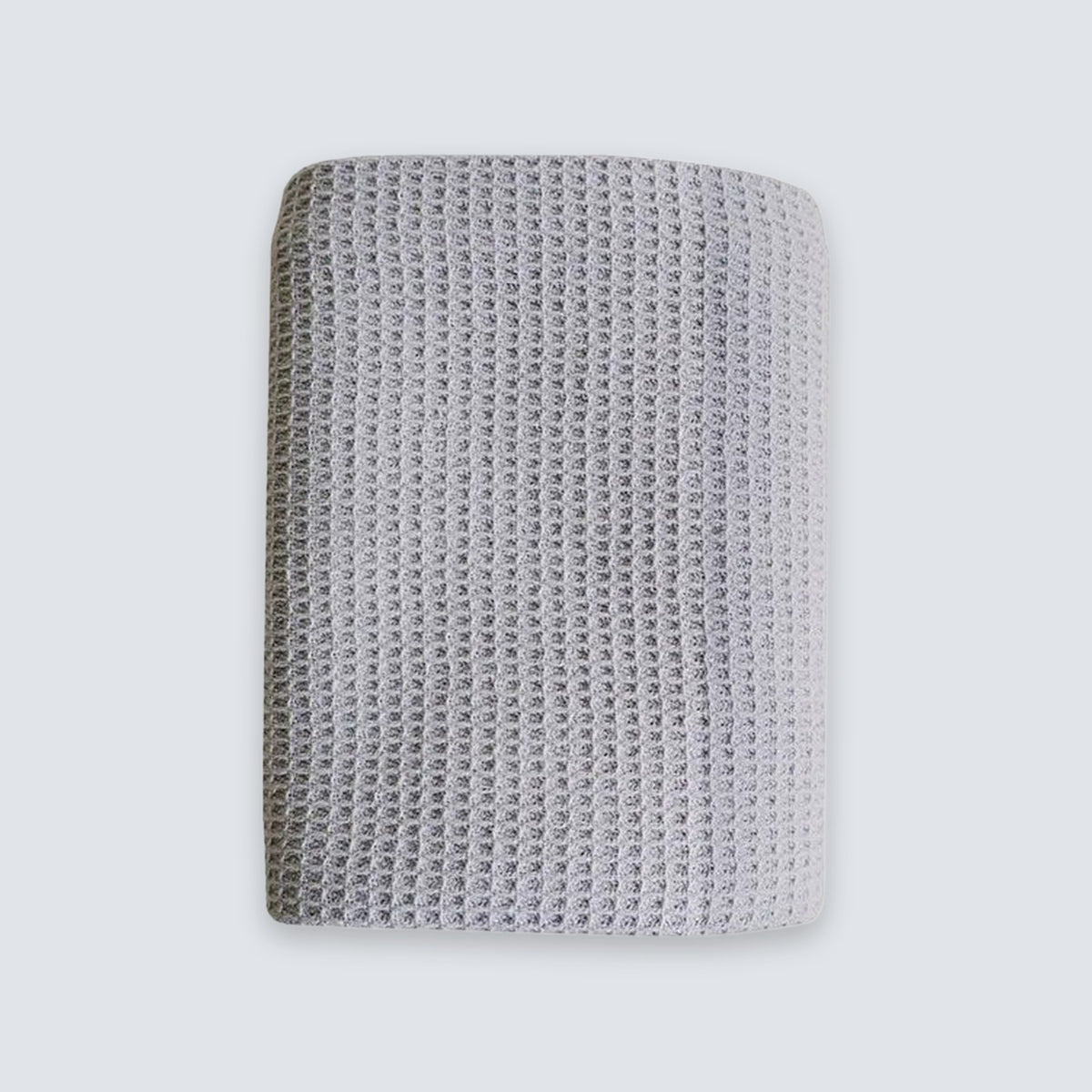 A square gray knit fabric wristband or cuff with a textured waffle pattern, shown against a light gray background.
